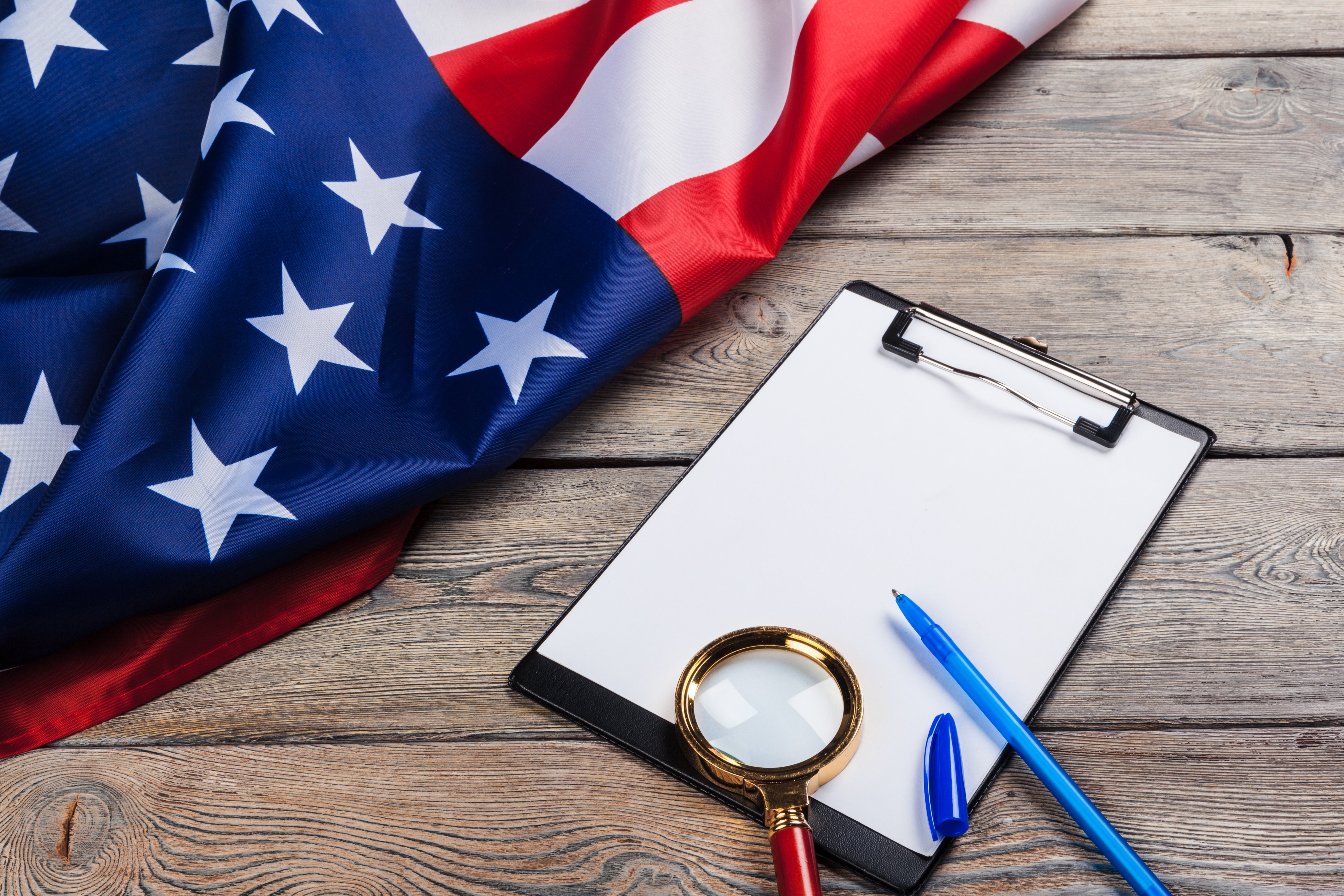 blank-clip-board-and-usa-flag-on-wooden-background-2025-02-25-09-46-02-utc