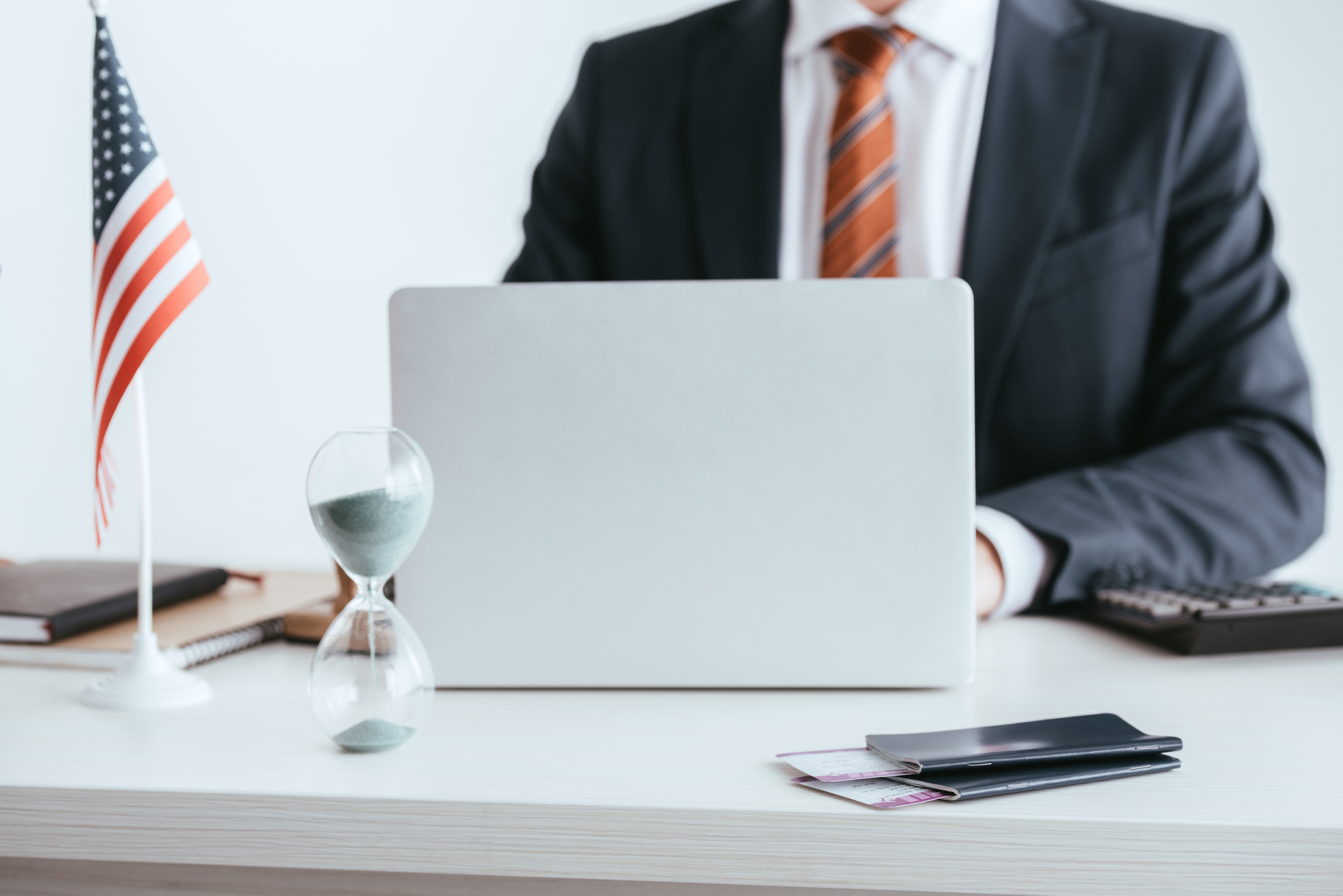 business-man-at-desk-with-laptop-and-flags-2026-01-05-23-57-38-utc