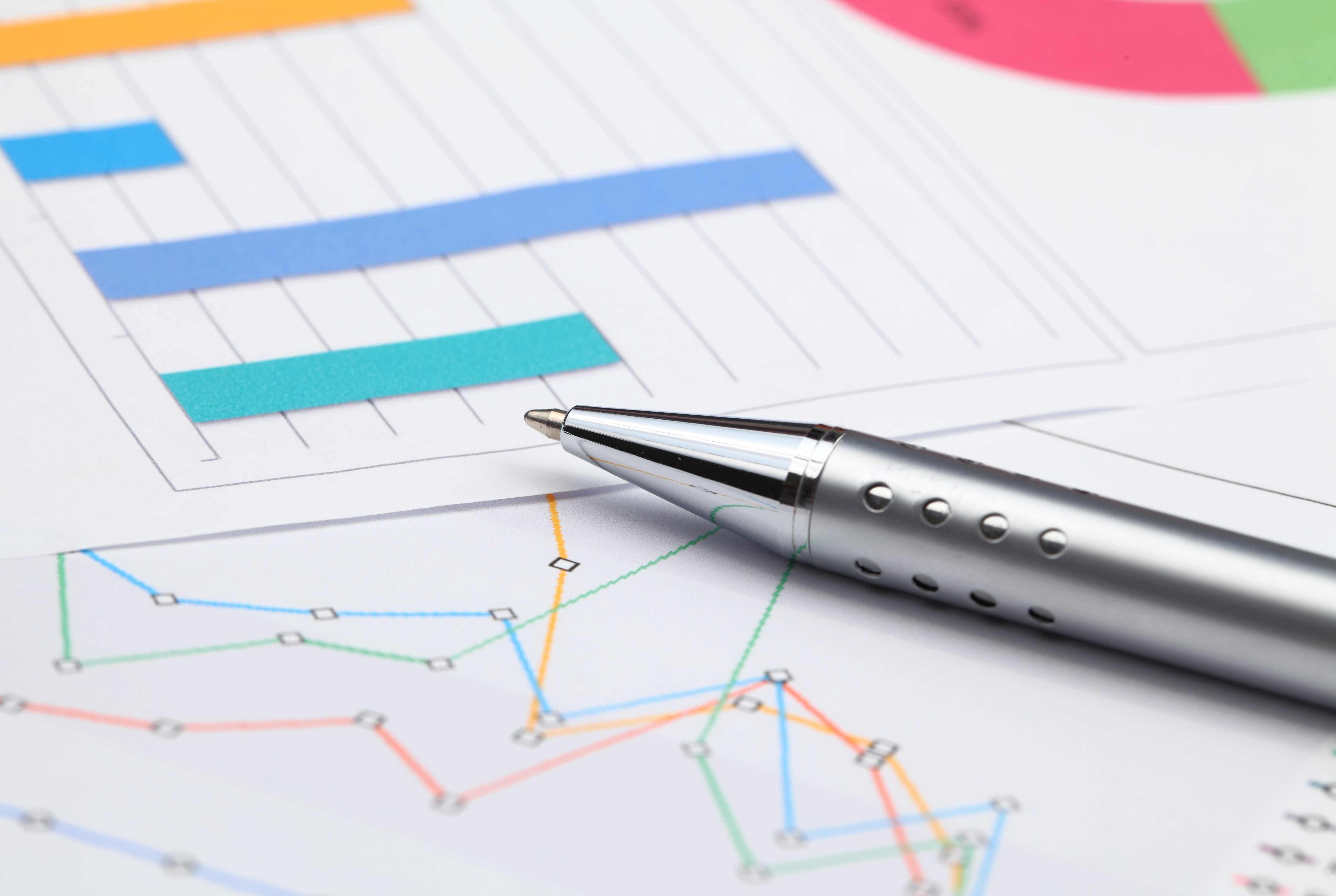 financial-charts-and-silver-pen-for-analysis-2026-03-24-23-45-08-utc